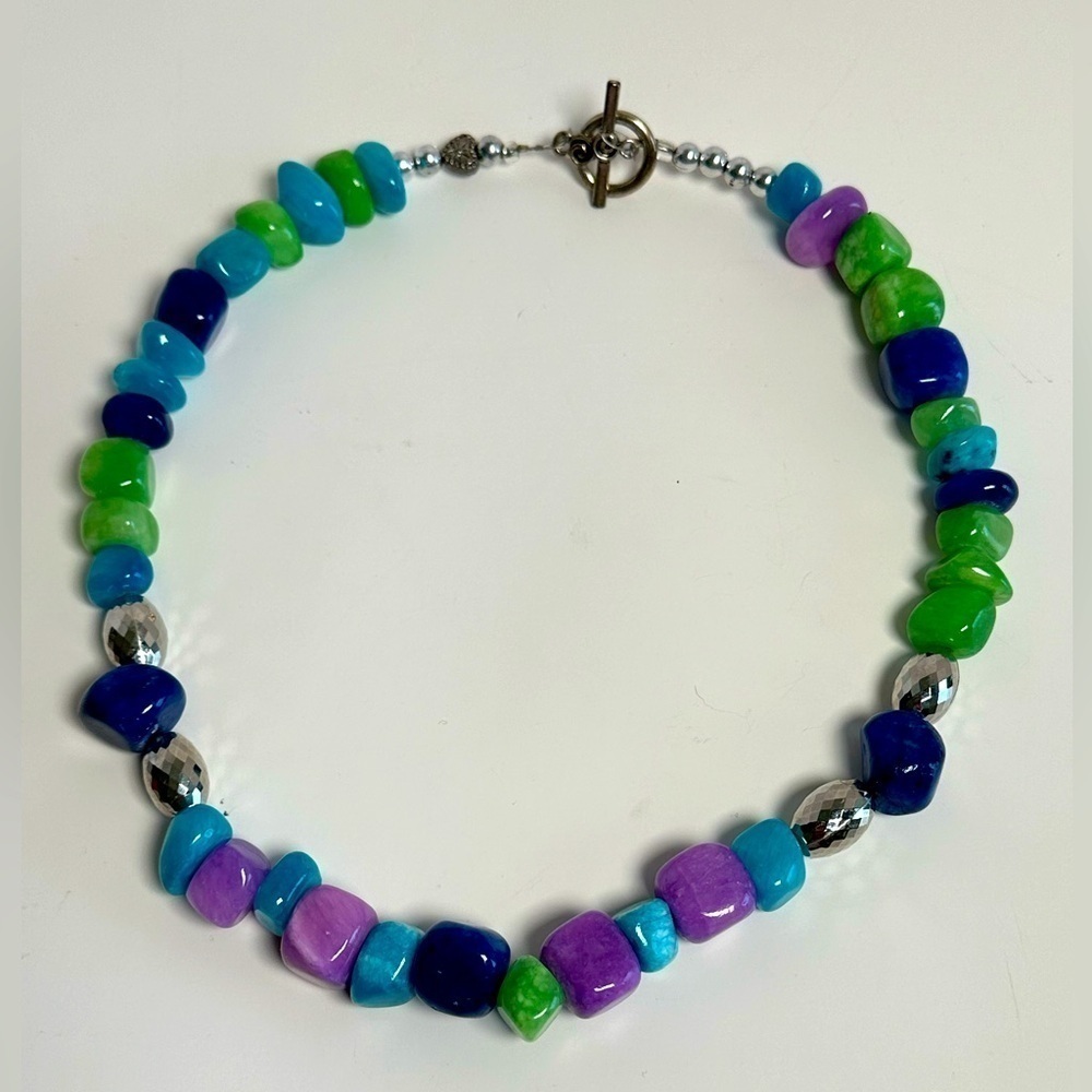 Hand crafted beaded necklace with beautiful purple, blue, & green stones.
